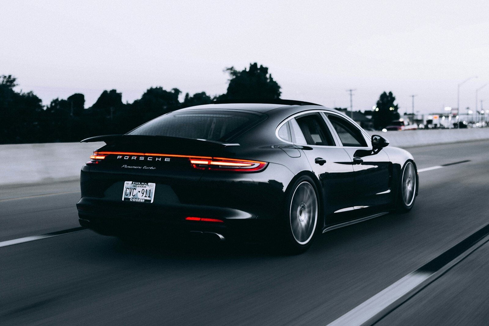 Black Porsche Panamera driving on a highway