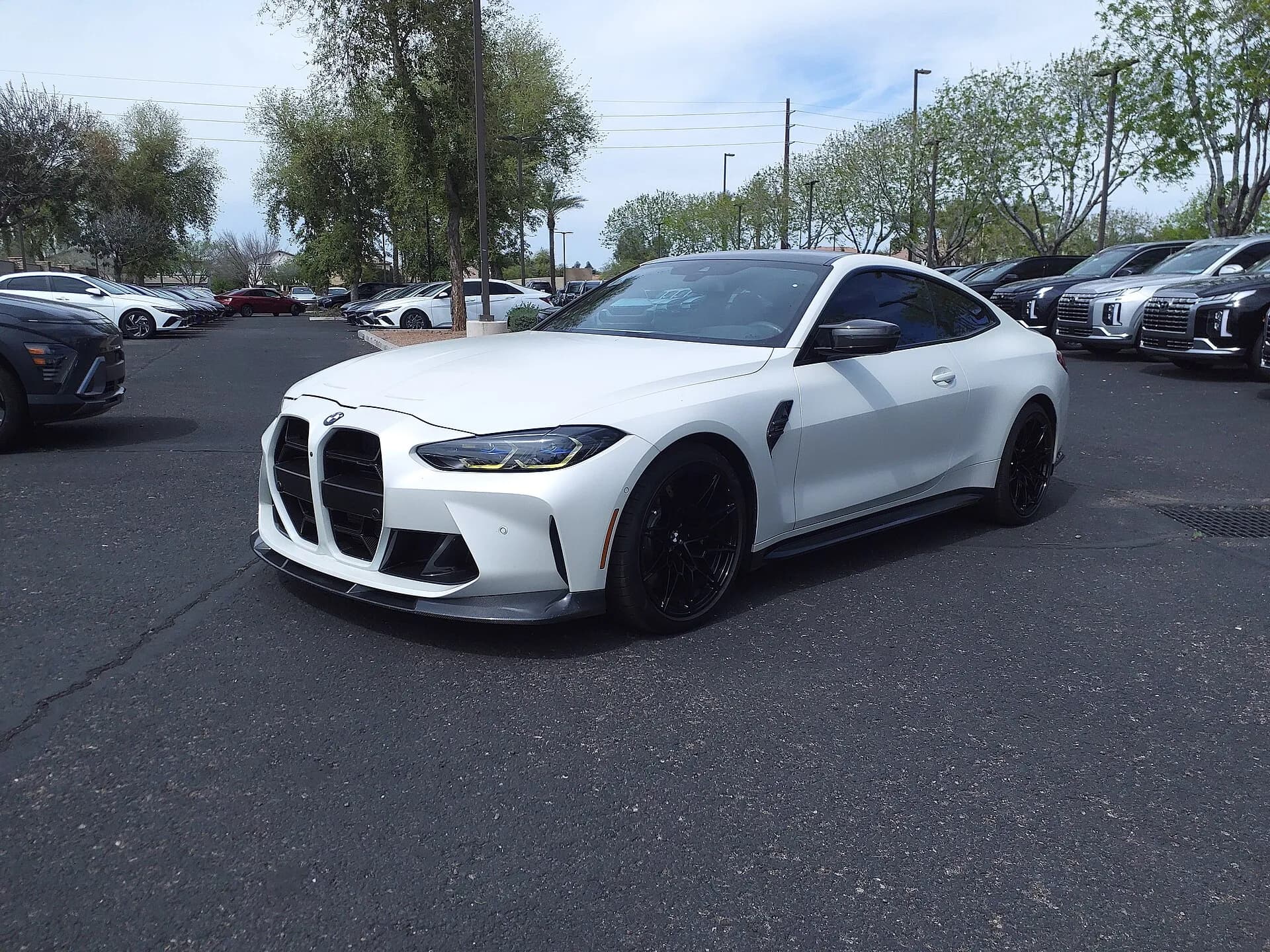 White BMW M4 Competition front three-quarter view