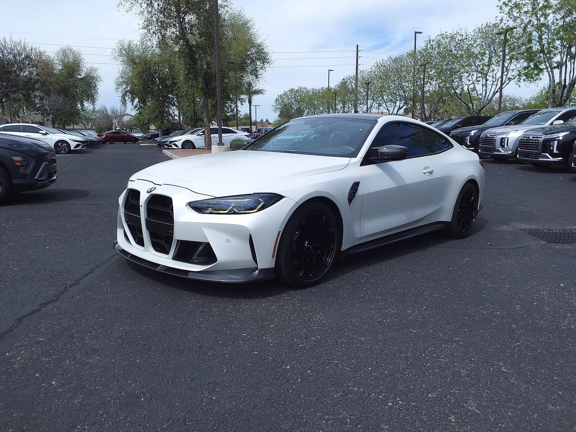 White BMW M4 Competition front three-quarter view
