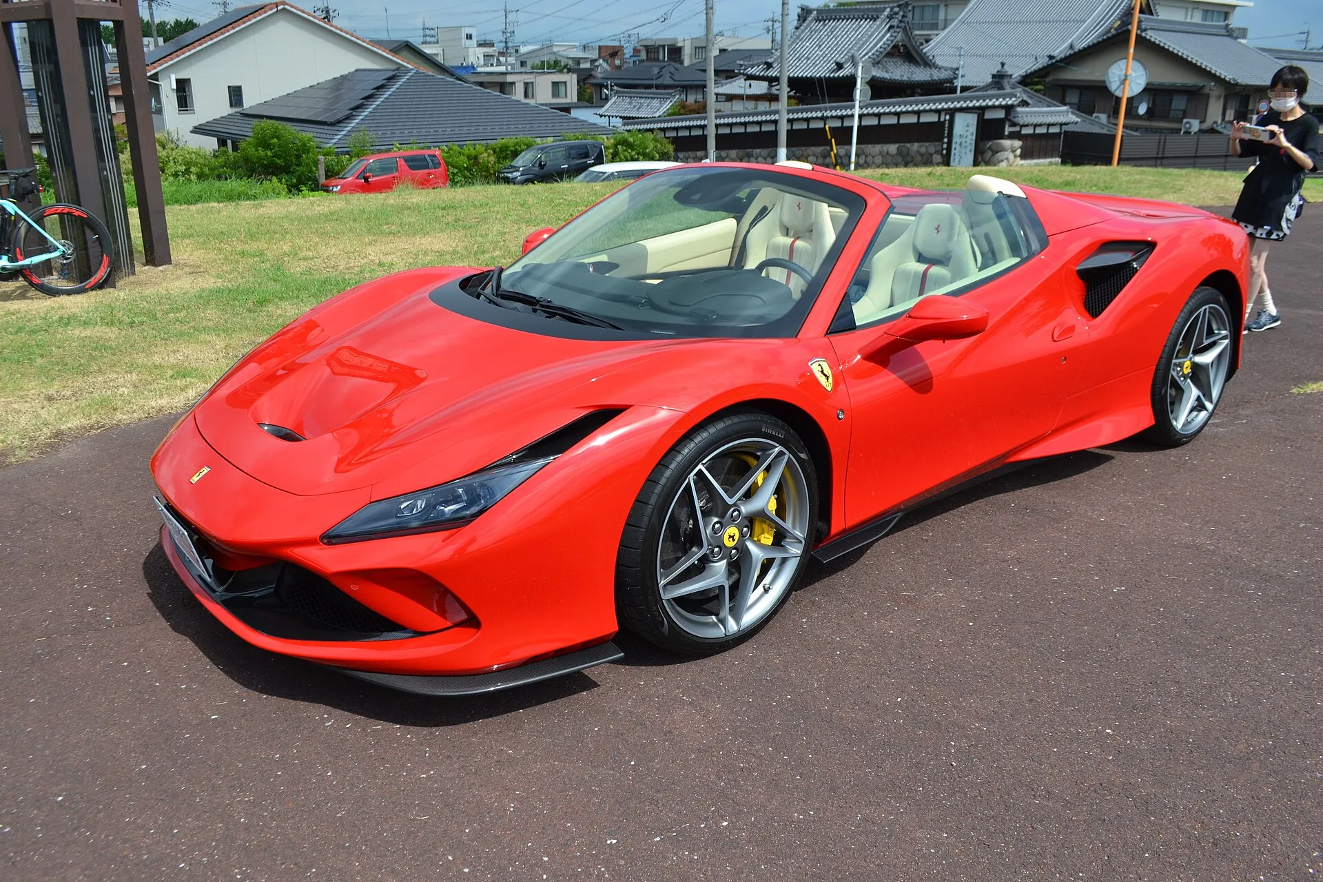 Red Ferrari F8 Spider with the roof down