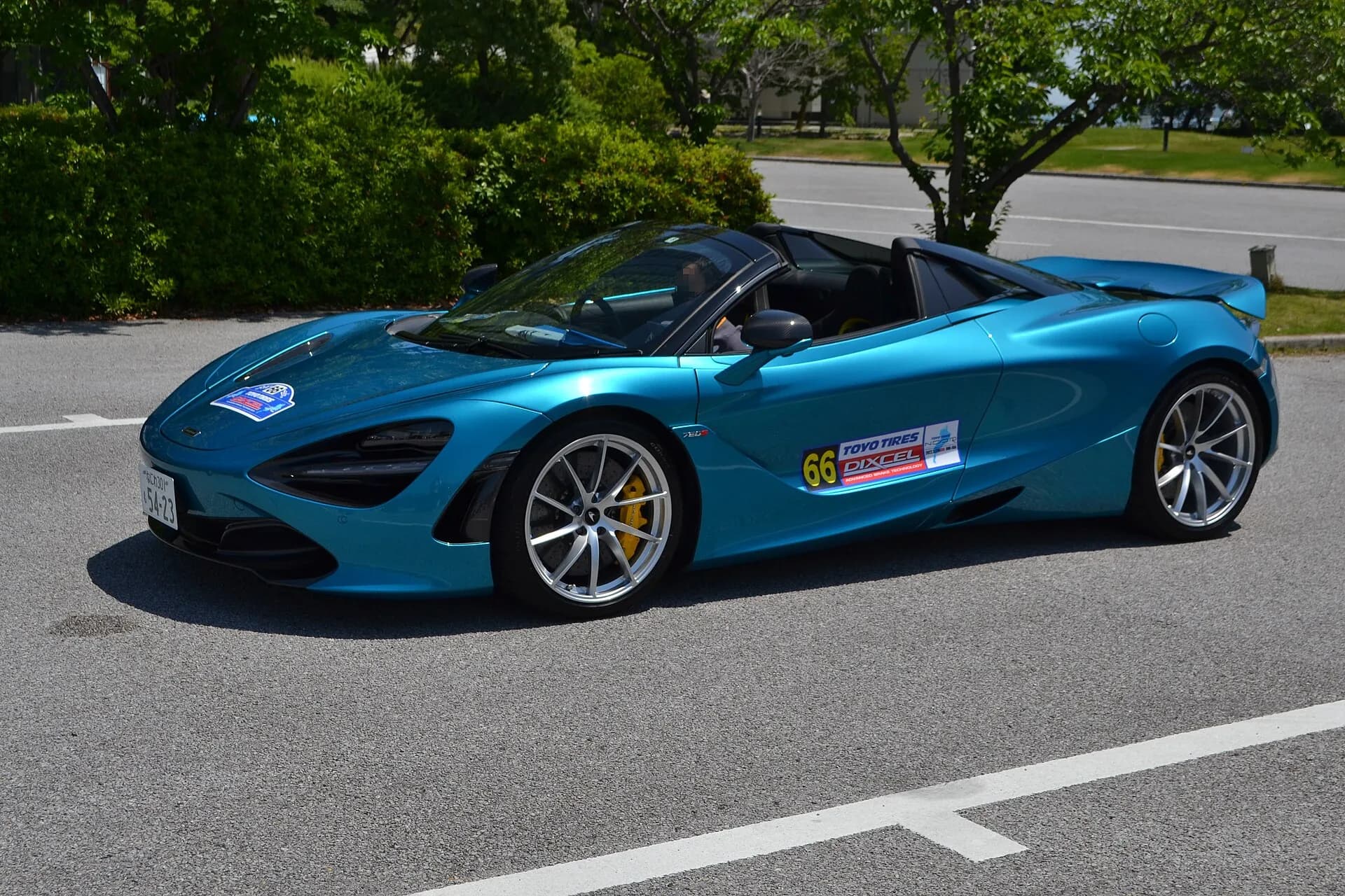 Blue McLaren 720S Spider with the roof down